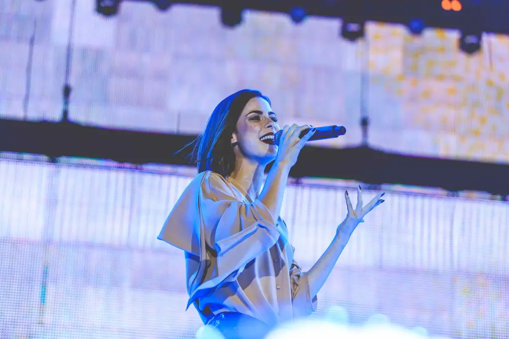 Female singer performing on stage with a microphone during a live event at the BMW Festival. Battle Royal Studios