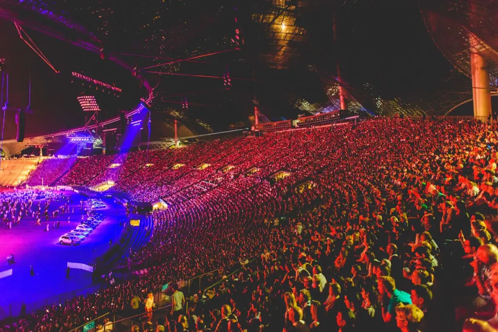 Massive crowd filling the stands of an outdoor stadium during a large-scale Event. BattleRoyal Studios