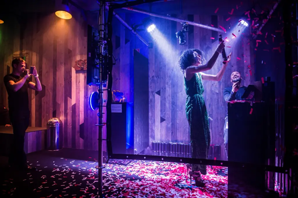 Woman celebrating with confetti while a man photographs the moment. Battle Royal Studios