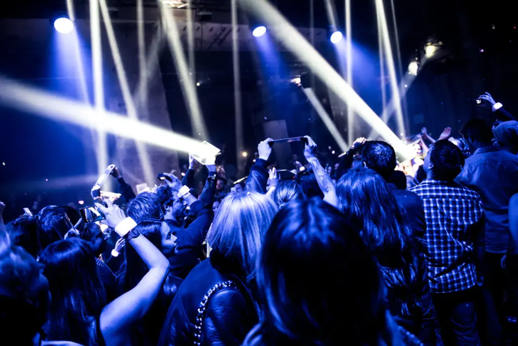 Crowd enjoying a live performance with intense spotlights. Battle Royal Studios