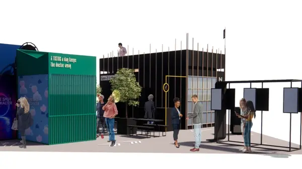 A design visualisation of a dark exhibition structure with a green panelled wall and an open black frame, with simplified human figures placed around it for scale.