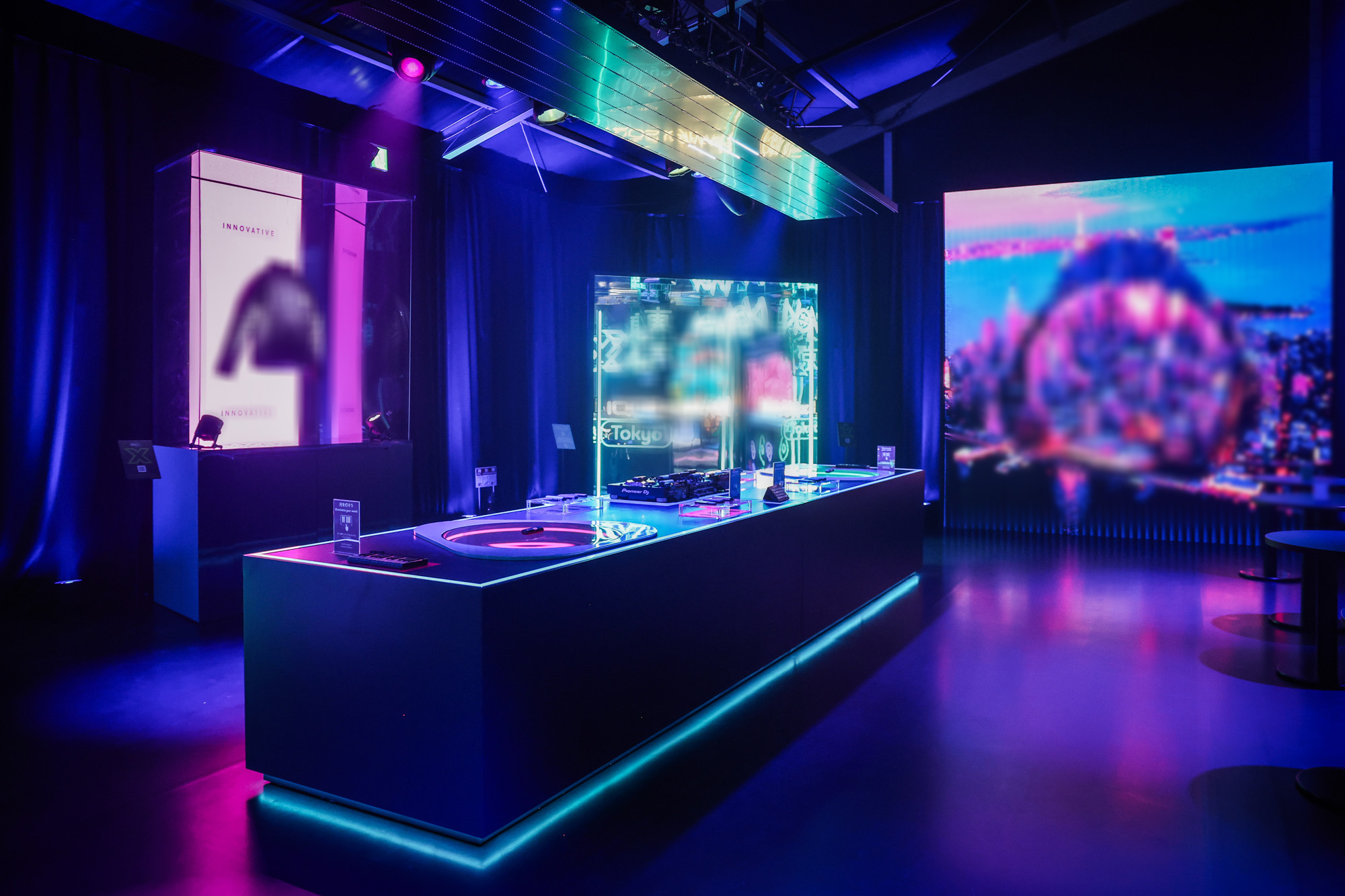 Futuristic event space with neon-lit interactive stations, digital displays, and a sleek modern design Battle Royal Studios