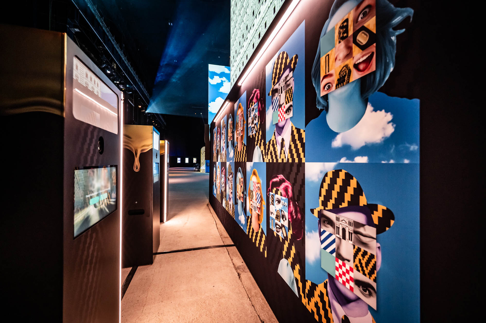 Corridor lined with colourful illustrated portraits of the 20 collaborating artists.
