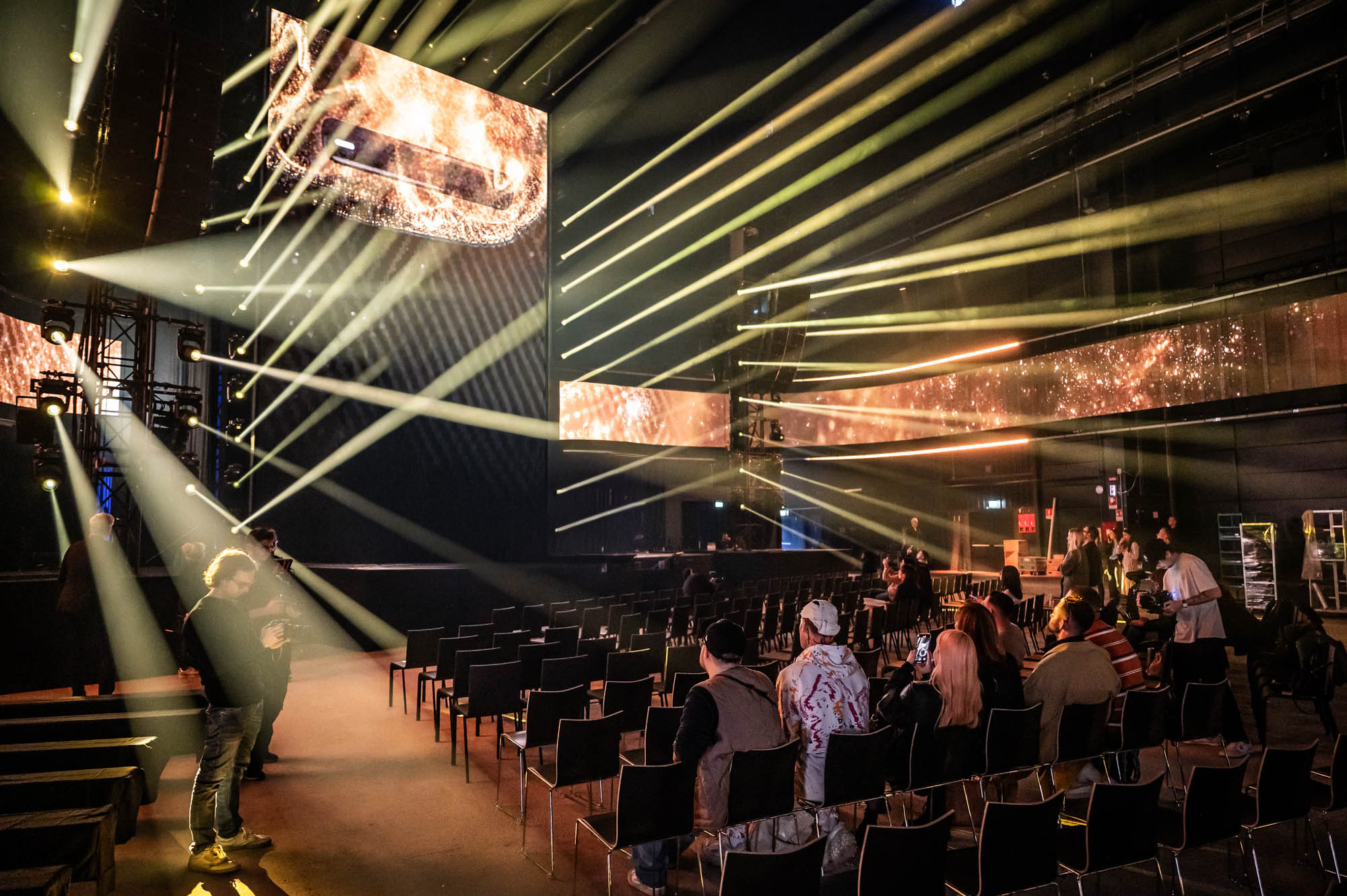 Crew testing light cues over rows of empty seats before the press preview.